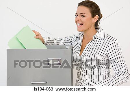 Businesswoman filing View Large Photo Image Stock Image - Businesswoman filing. Fotosearch