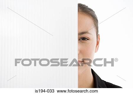 Stock Image - Businesswoman hiding behind a partition. Fotosearch