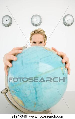 Stock Photo - Businesswoman holding a globe. Fotosearch