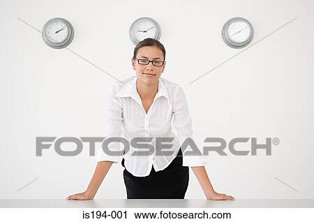 Businesswoman stood in front of three wall clocks View Large Photo Image Stock Image - Businesswoman stood in front of three wall clocks. Fotosearch