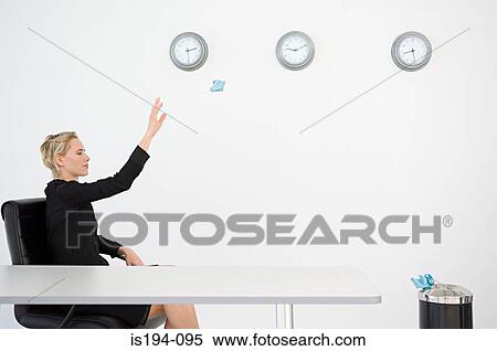 Businesswoman throwing paper into bin View Large Photo Image Stock Photography - Businesswoman throwing paper into bin. Fotosearch