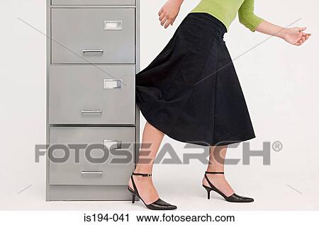 Businesswoman with skirt trapped in drawer View Large Photo Image Stock Image - Businesswoman with skirt trapped in drawer. Fotosearch