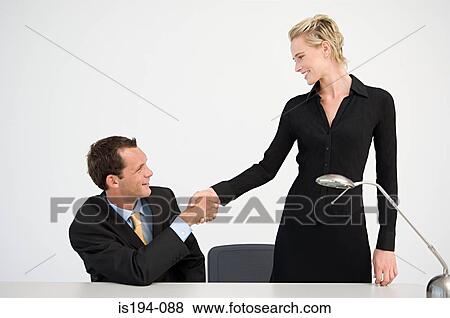 Stock Photo - Handshake between two office workers. Fotosearch