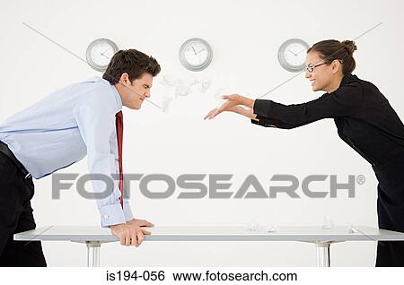 Woman throwing screwed up paper at man View Large Photo Image Stock Photograph - Woman throwing screwed up paper at man. Fotosearch