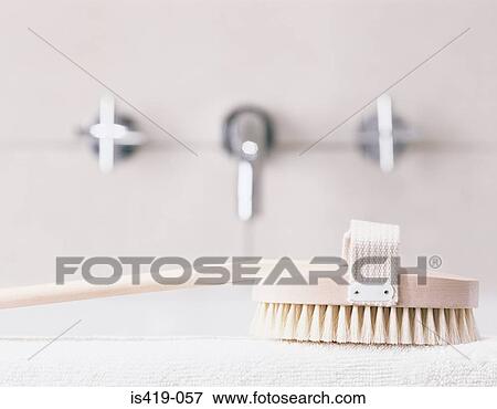 Backbrush on the edge of a bath View Large Photo Image Stock Photo - Backbrush on the edge of a bath. Fotosearch
