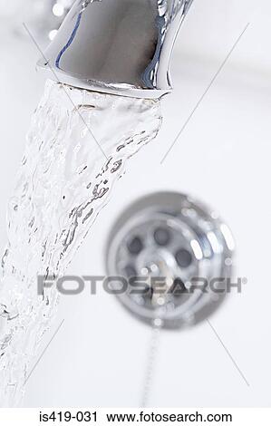 Stock Image - Bath tap running. Fotosearch