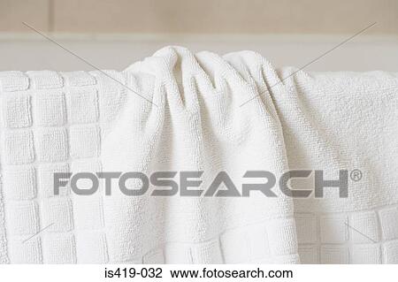 Towel on the edge of a bath View Large Photo Image Stock Image - Towel on the edge of a bath. Fotosearch