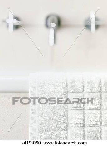 Stock Image - Towel on the edge of the bath. Fotosearch
