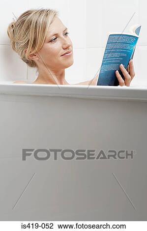 Woman reading in the bath View Large Photo Image Stock Image - Woman reading in the bath. Fotosearch