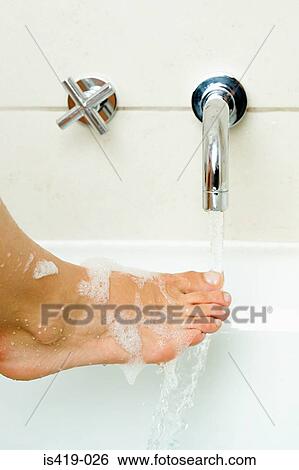 Woman rinsing her foot View Large Photo Image Stock Photograph - Woman rinsing her foot. Fotosearch