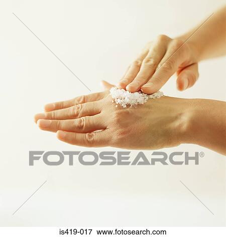 Stock Photo - Woman using salt scrub. Fotosearch