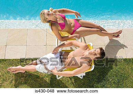 Couple sunbathing View Large Photo Image Stock Photo - Couple sunbathing. Fotosearch