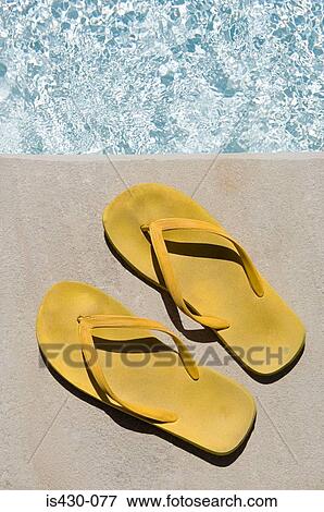 Flip flops by the pool View Large Photo Image Stock Photo - Flip flops by the pool. Fotosearch