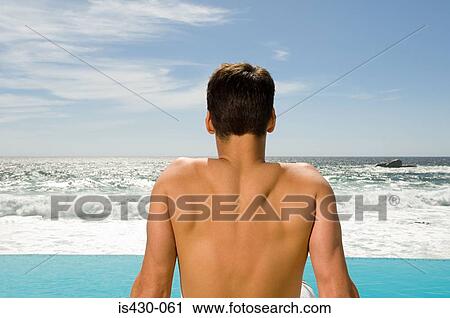 Man looking at the sea View Large Photo Image Stock Image - Man looking at the sea. Fotosearch