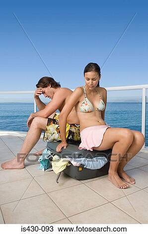 Stressed couple with suitcase View Large Photo Image Stock Image - Stressed couple with suitcase. Fotosearch