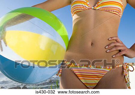 Woman holding a beachball View Large Photo Image Stock Image - Woman holding a beachball. Fotosearch