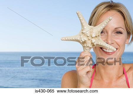 Woman holding a starfish View Large Photo Image Stock Photography - Woman holding a starfish. Fotosearch