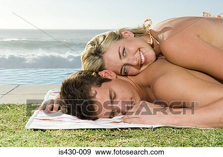 Stock Photo - Woman lying on her boyfriend. Fotosearch