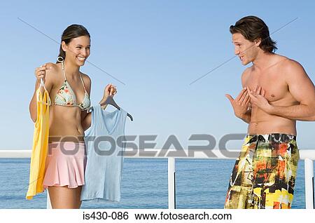 Woman showing clothing to boyfriend View Large Photo Image Stock Photograph - Woman showing clothing to boyfriend. Fotosearch