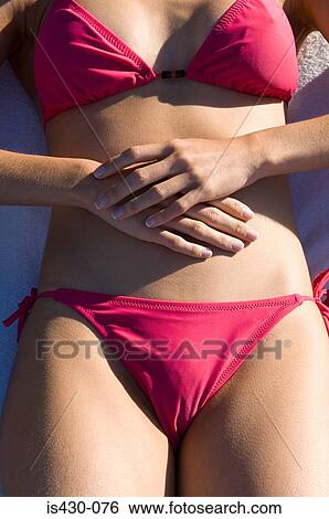 Stock Photograph - Woman wearing a pink bikini. Fotosearch