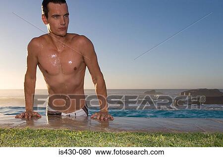 Young man emerging from pool View Large Photo Image Stock Image - Young man emerging from pool. Fotosearch