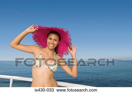 Stock Image - Young woman in a sunhat. Fotosearch