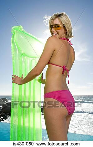 Young woman with inflatable mattress View Large Photo Image Stock Image - Young woman with inflatable mattress. Fotosearch