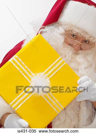 Stock Photography - Santa with a present. Fotosearch