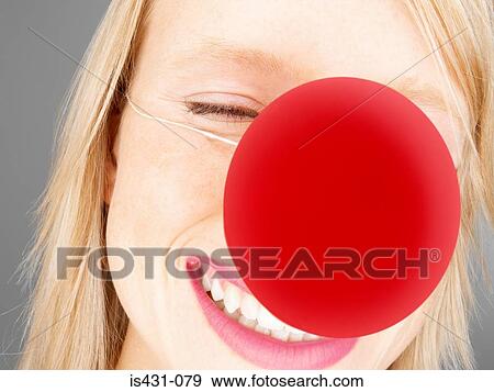 Stock Photo - Woman wearing a clowns nose. Fotosearch