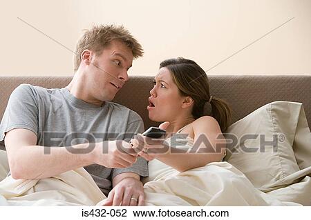 Couple arguing over remote control View Large Photo Image Stock Image - Couple arguing over remote control. Fotosearch