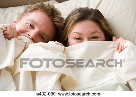 Couple hiding under sheet View Large Photo Image Stock Image - Couple hiding under sheet. Fotosearch