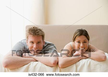 Couple lying on bed View Large Photo Image Stock Photograph - Couple lying on bed. Fotosearch