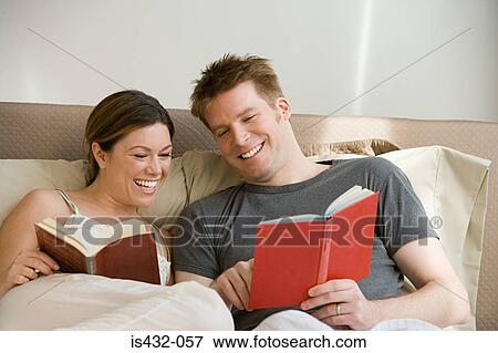Couple reading in bed View Large Photo Image Stock Photo - Couple reading in bed. Fotosearch
