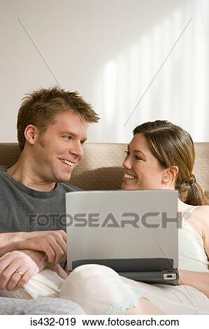 Stock Photo - Couple with laptop computer. Fotosearch