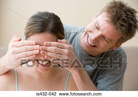Man covering wife's eyes View Large Photo Image Stock Image - Man covering wife's eyes. Fotosearch
