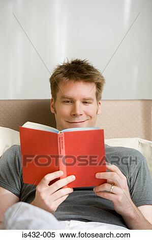 Man reading in bed View Large Photo Image Stock Photography - Man reading in bed. Fotosearch