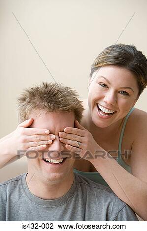 Woman covering husband's eyes View Large Photo Image Stock Image - Woman covering husband's eyes. Fotosearch