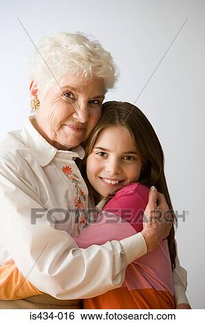 Stock Photograph - Girl and grandmother hugging. Fotosearch