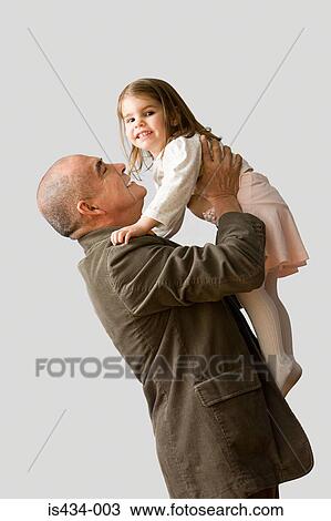 Grandfather lifting granddaughter View Large Photo Image Stock Image - Grandfather lifting granddaughter. Fotosearch