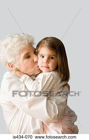 Grandmother kissing granddaughter View Large Photo Image Stock Image - Grandmother kissing granddaughter. Fotosearch
