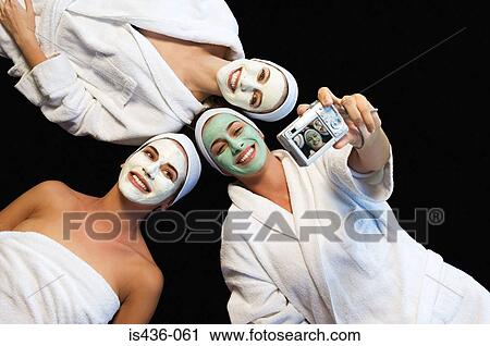 Stock Image - Friends in face masks taking a picture. Fotosearch