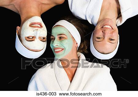 Stock Image - Friends wearing facial masks. Fotosearch