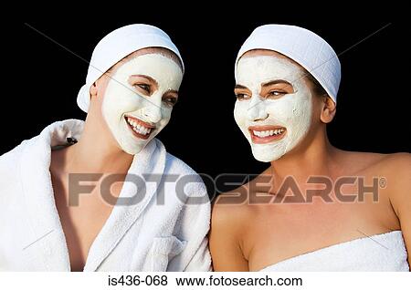 Stock Photo - Two women wearing face masks. Fotosearch