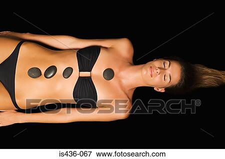 Stock Photo - Woman having stone therapy. Fotosearch