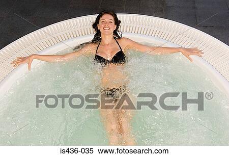 Stock Photography - Woman in a jacuzzi. Fotosearch