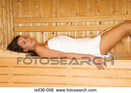 Stock Photo - Woman lying down in sauna. Fotosearch