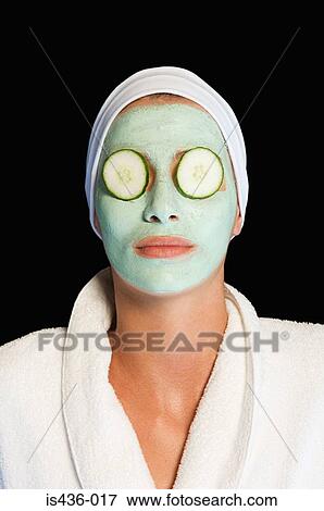 Woman wearing facial mask and cucumber slices View Large Photo Image Stock Photo - Woman wearing facial mask and cucumber slices. Fotosearch