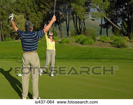 Couple playing golf View Large Photo Image Picture - Couple playing golf. Fotosearch