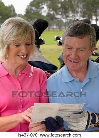 Couple with golf score card View Large Photo Image Stock Image - Couple with golf score card. Fotosearch