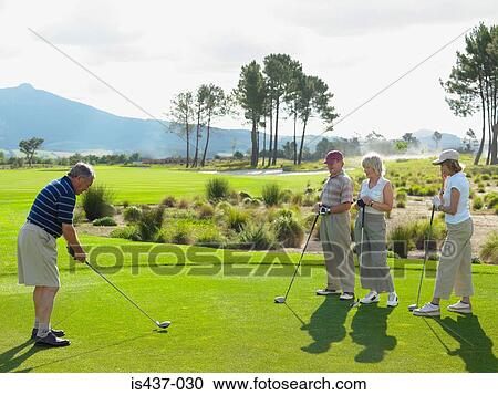 Stock Image - Friends playing golf. Fotosearch